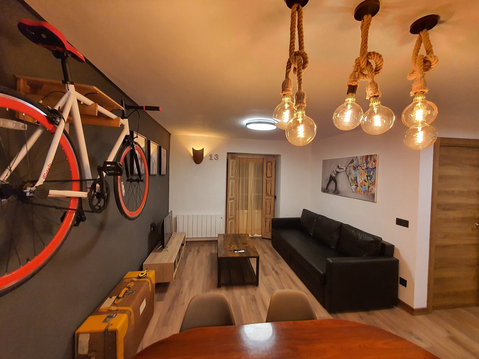 Living room with decorative touches: bicycle and pendant lights