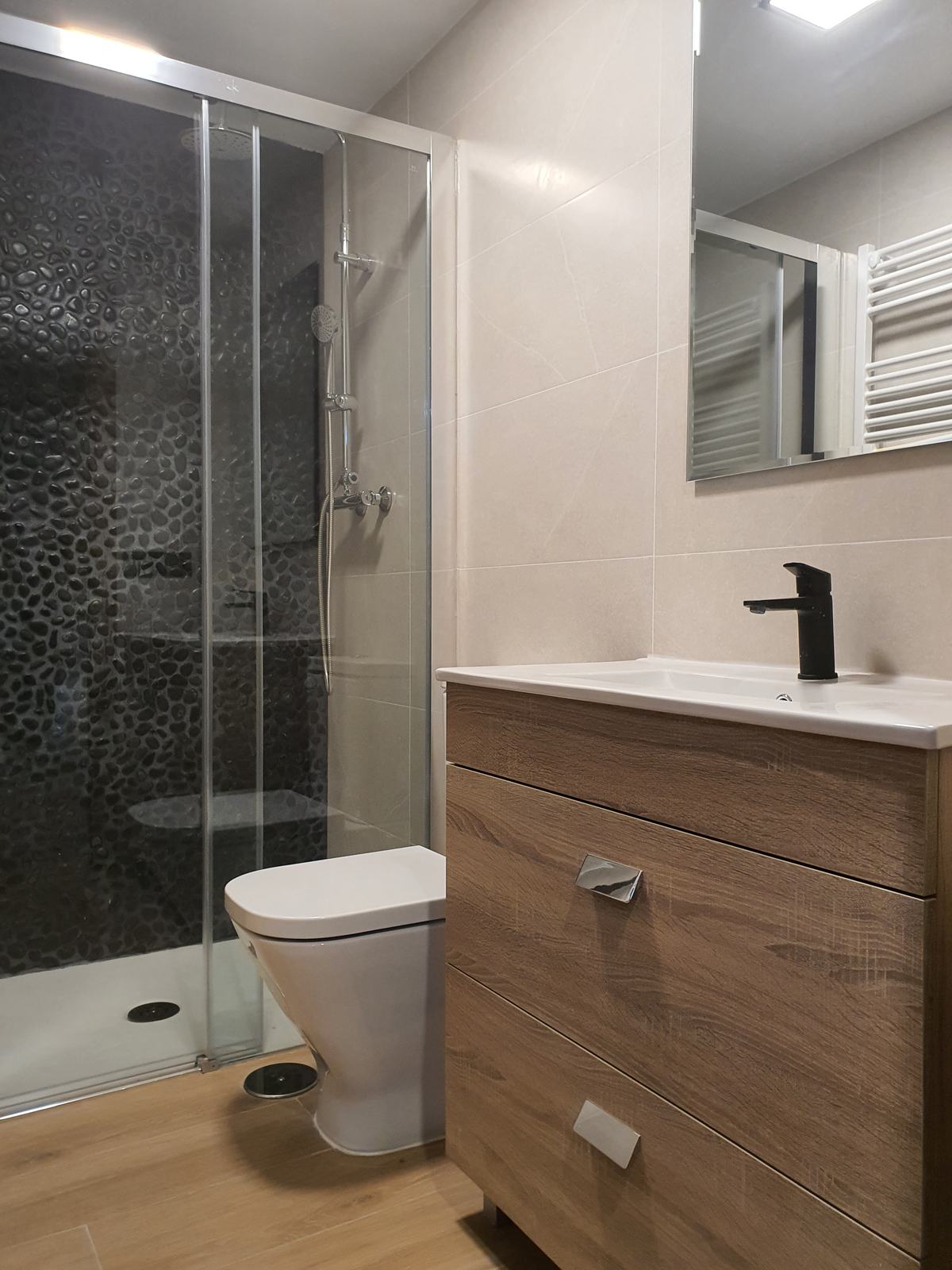 Bathroom with shower and matching cabinet